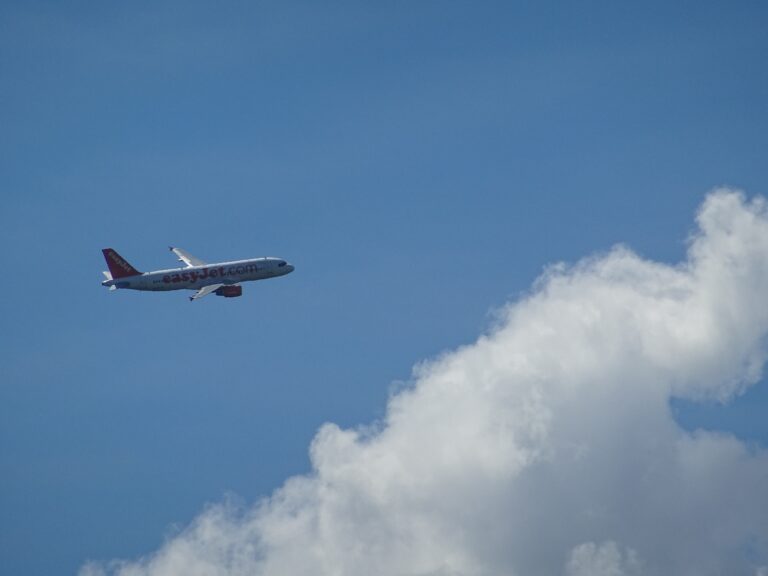 Commercial aircraft flying above cloud layer