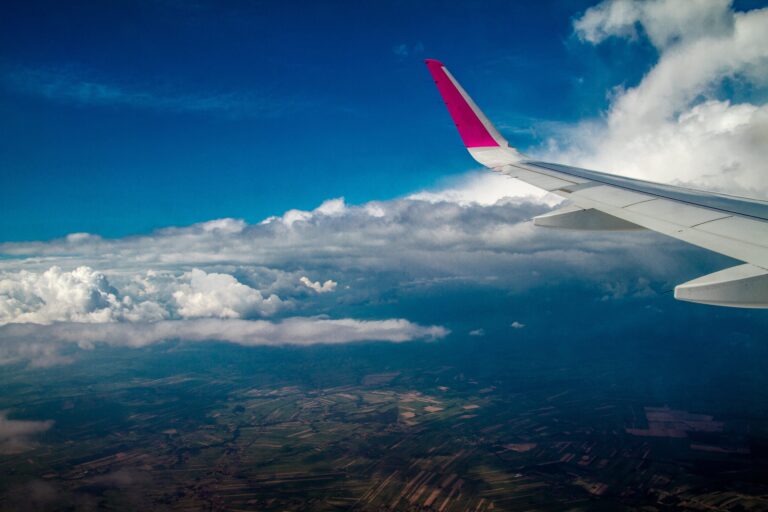 View from airplane window showing clouds and wing