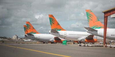 Multiple planes lined up on airport tarmac illustrating capacity constraints